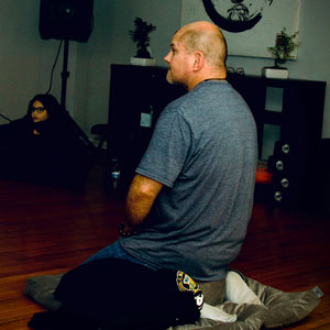 man meditating on pillow
